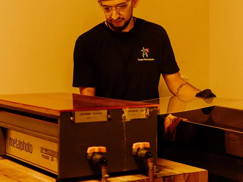 A plate running through the Metalphoto processor